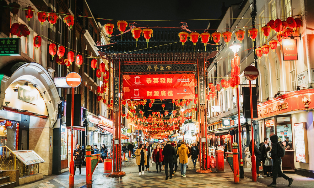 Streets of London’s Chinatown with red lanterns, traditional gates, and bustling restaurants.