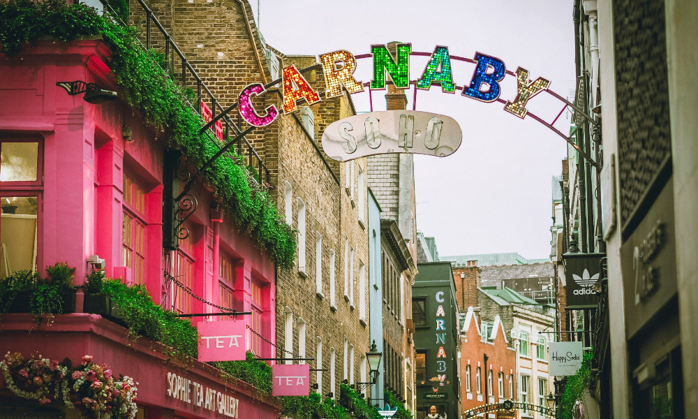 Street view of Soho’s Carnaby Street with its iconic signage and lively atmosphere.