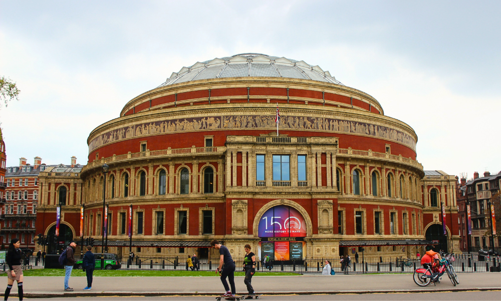 Exterior view of the Royal Albert Hall in London, showing its circular Victorian architecture and grand entrance.