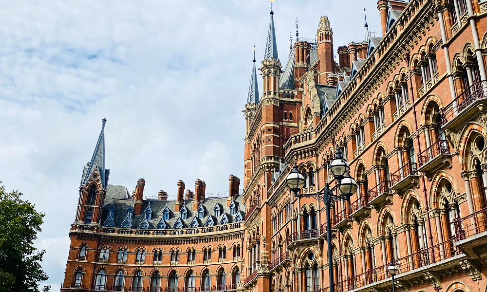 Exterior view of St Pancras International train station in London, showcasing its Victorian architecture and grand façade.