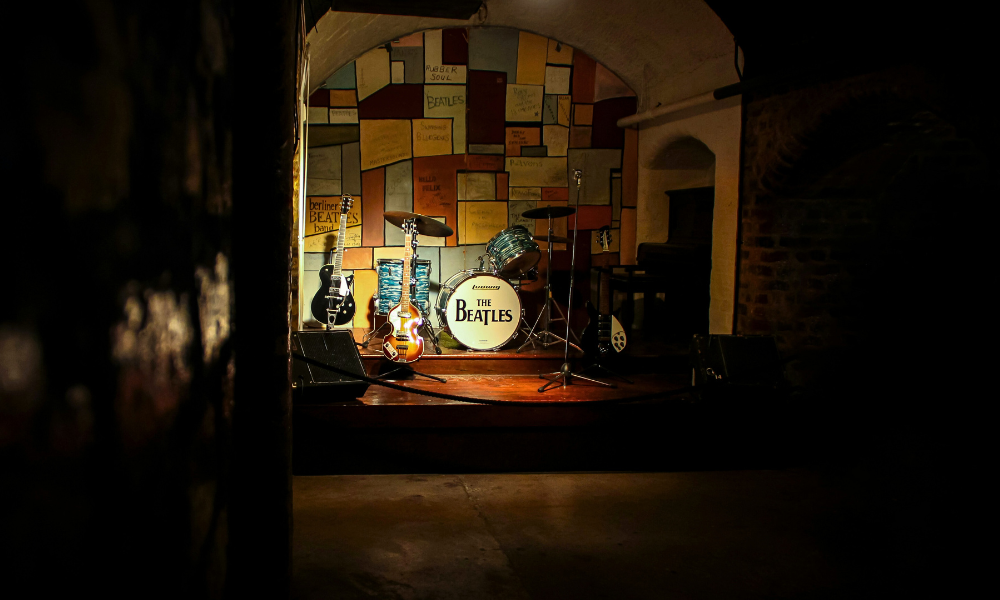 Stage with a Beatles-themed drum kit in a music venue in Liverpool.